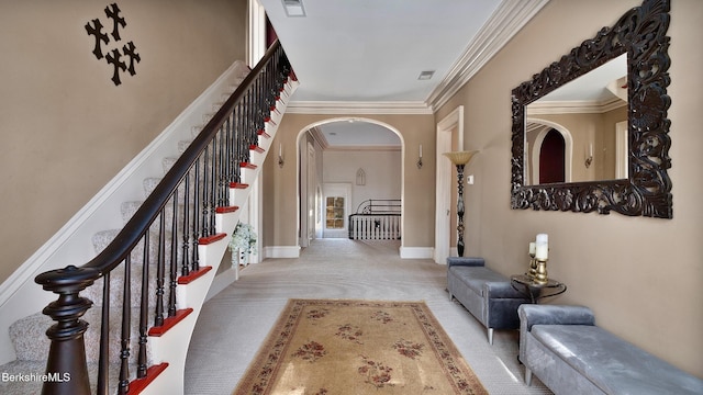 6 Eileen Dr, Rensselaer, NY 12144 - entrance foyer featuring visible vents, crown molding, baseboards, carpet floors, and arched walkways