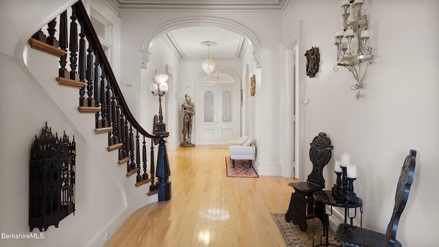 6 Eileen Dr, Rensselaer, NY 12144 - foyer entrance with hardwood / wood-style floors, stairs, arched walkways, and ornamental molding