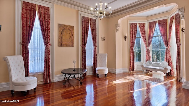 6 Eileen Dr, Rensselaer, NY 12144 - living area with a wealth of natural light, crown molding, an inviting chandelier, and hardwood / wood-style floors