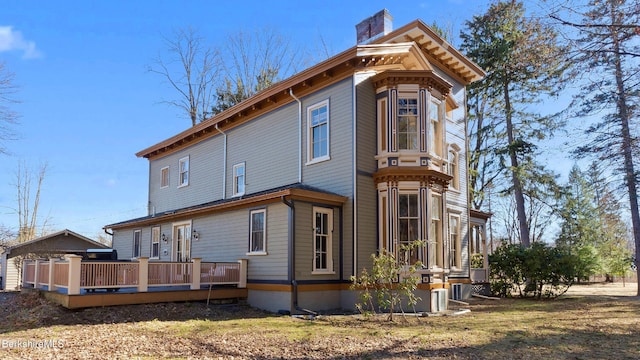 6 Eileen Dr, Rensselaer, NY 12144 - rear view of house with a wooden deck and a chimney