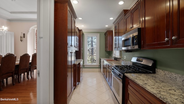 6 Eileen Dr, Rensselaer, NY 12144 - kitchen with light stone counters, a sink, recessed lighting, appliances with stainless steel finishes, and crown molding