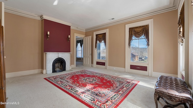 6 Eileen Dr, Rensselaer, NY 12144 - carpeted living room featuring a fireplace with flush hearth, visible vents, crown molding, and baseboards