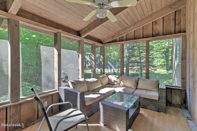 sunroom with beamed ceiling, outdoor lounge area, and a ceiling fan