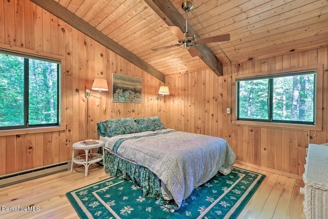 bedroom featuring multiple windows, wood-type flooring, and vaulted ceiling with beams