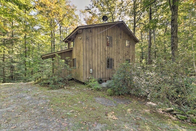 view of outbuilding featuring a forest view