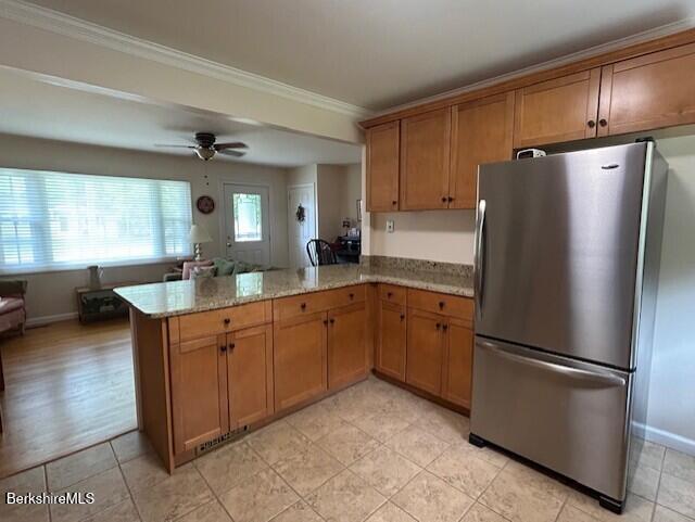 62 Maple Grove Dr, Pittsfield, MA 01201 - kitchen with freestanding refrigerator, a peninsula, light stone countertops, ornamental molding, and ceiling fan