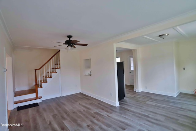 unfurnished living room with ceiling fan, wood-type flooring, and ornamental molding