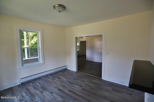 spare room featuring dark hardwood / wood-style flooring and a baseboard radiator