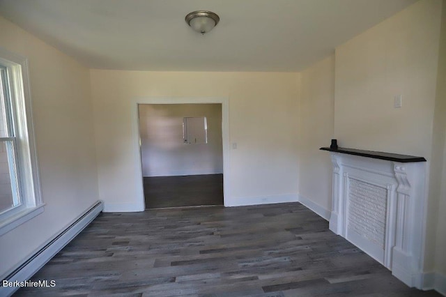 interior space featuring baseboard heating and dark hardwood / wood-style floors