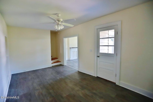 spare room with ceiling fan and dark wood-type flooring