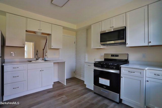 kitchen with white cabinets, appliances with stainless steel finishes, and sink