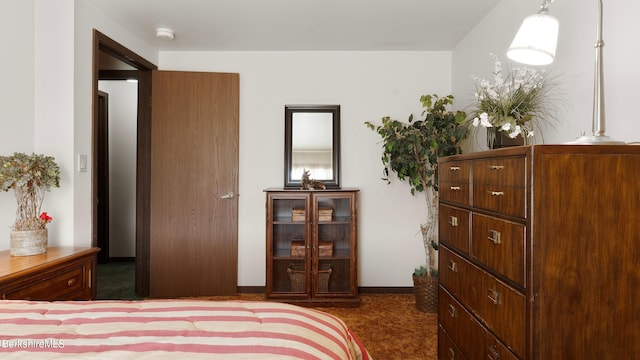 bedroom with dark colored carpet