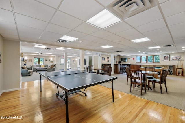 rec room featuring a paneled ceiling, visible vents, and light wood finished floors