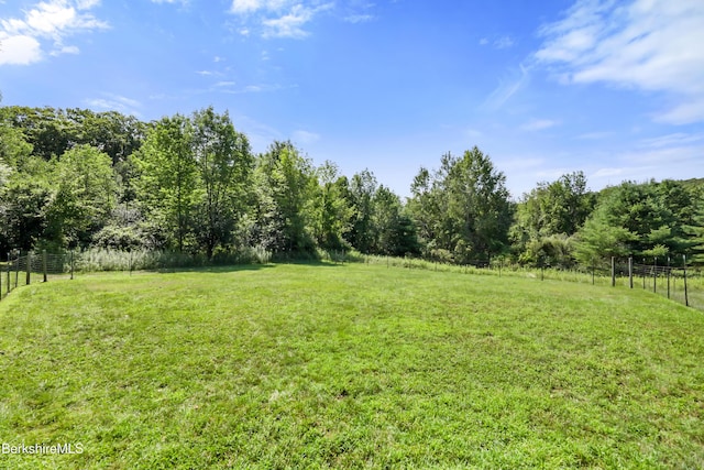 view of yard featuring a rural view and fence