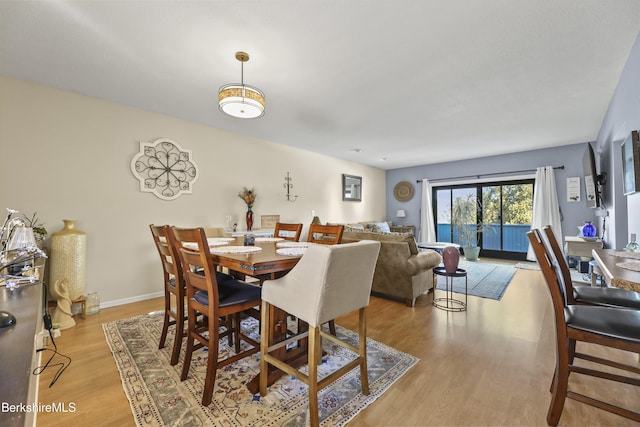 dining room with light wood-style flooring and baseboards