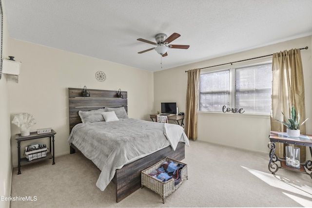 carpeted bedroom with a textured ceiling and ceiling fan