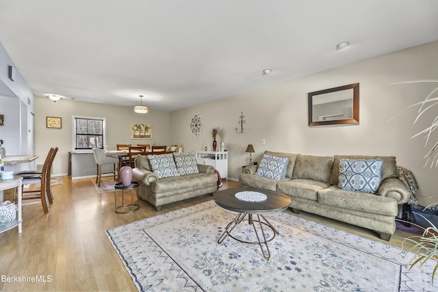 living area featuring light wood finished floors and baseboards