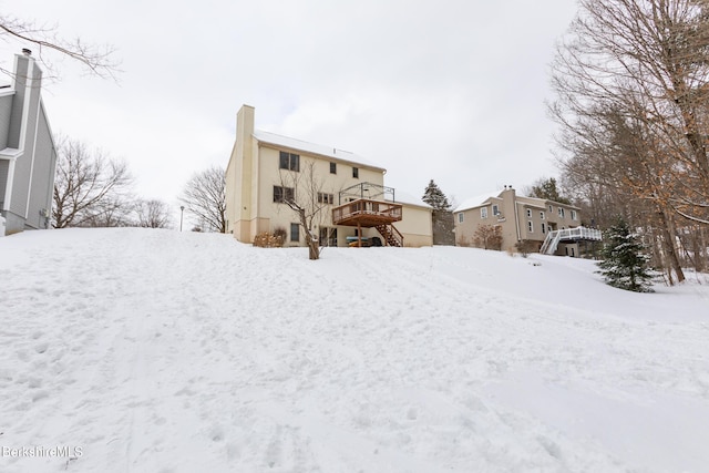 snowy yard featuring a wooden deck