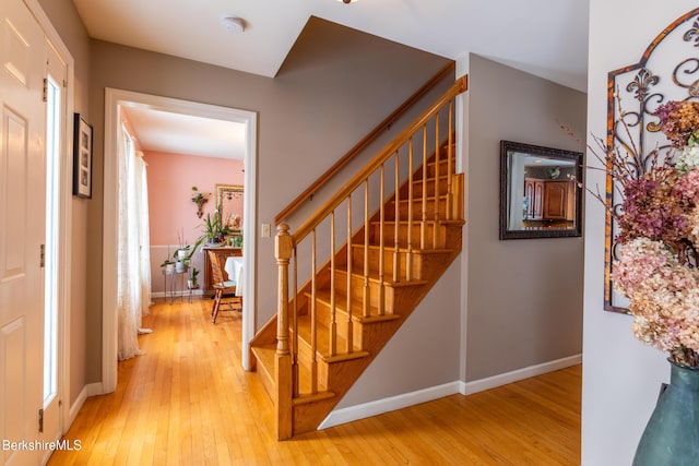 stairs with hardwood / wood-style floors