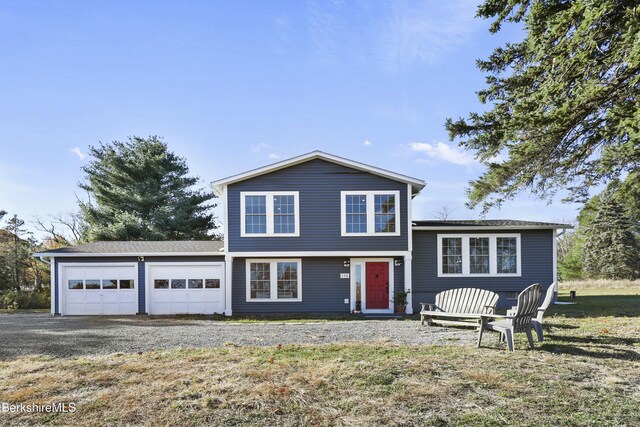 view of front of house with a garage and a front lawn