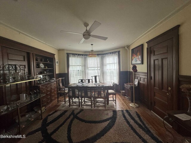 79 Chestnut St, North Adams, MA 01247 - dining room featuring a wainscoted wall, wood finished floors, a ceiling fan, and ornamental molding