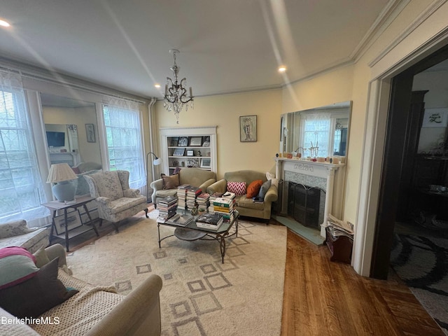 79 Chestnut St, North Adams, MA 01247 - living area featuring recessed lighting, a chandelier, crown molding, wood finished floors, and a fireplace