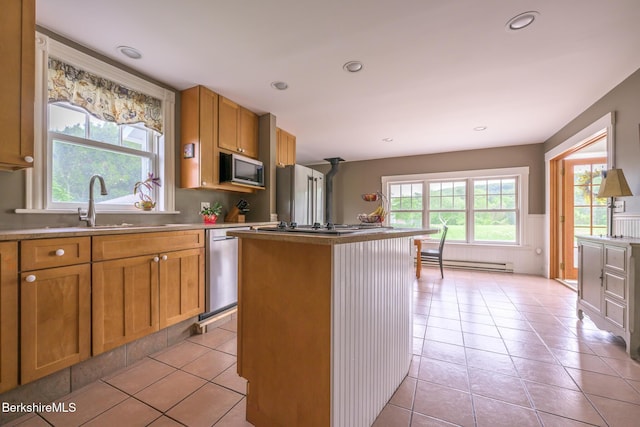 955 Barker Rd, Pittsfield, MA 01201 - kitchen with baseboard heating, appliances with stainless steel finishes, a wainscoted wall, a center island, and light tile patterned floors