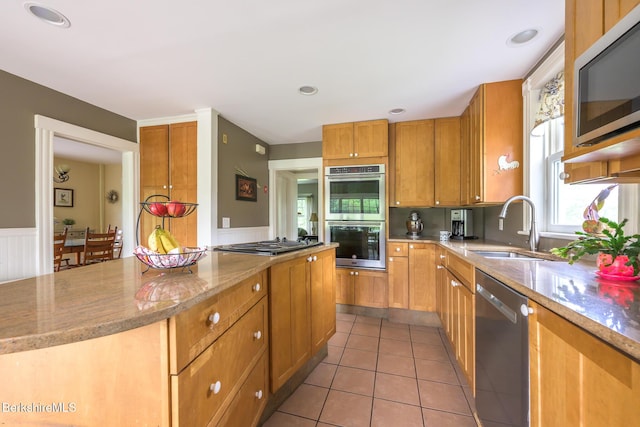 955 Barker Rd, Pittsfield, MA 01201 - kitchen with appliances with stainless steel finishes, a sink, a center island, light tile patterned flooring, and light stone counters
