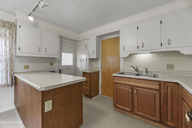 20 Summer St, Lee, MA 01238 - kitchen featuring a sink, light floors, light countertops, a peninsula, and white cabinetry