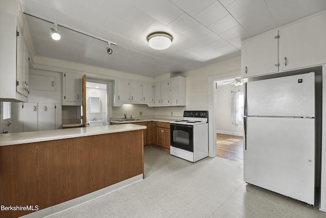 20 Summer St, Lee, MA 01238 - kitchen featuring track lighting, light countertops, electric range, a peninsula, and freestanding refrigerator