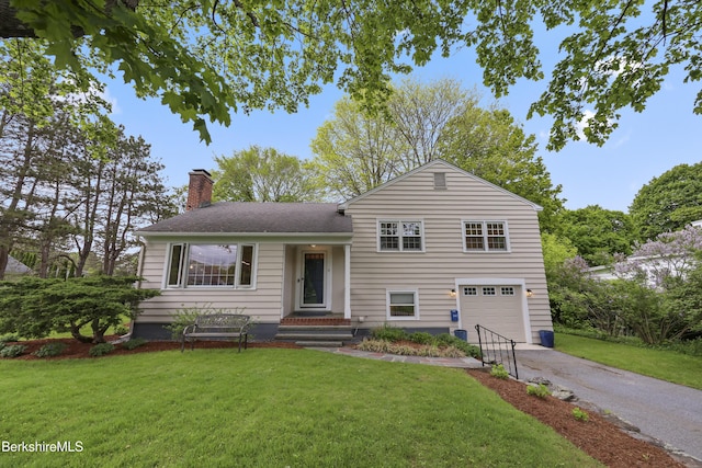 4 Woodlawn Dr, Williamstown, MA 01267 - tri-level home featuring a garage, a chimney, driveway, and a front lawn