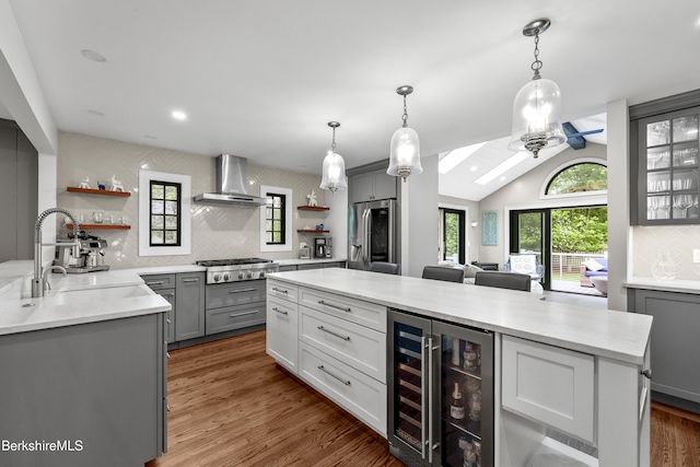 4 Woodlawn Dr, Williamstown, MA 01267 - kitchen with open shelves, wall chimney exhaust hood, stainless steel appliances, wine cooler, and backsplash