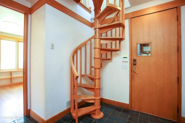 interior space with baseboards and tile patterned flooring