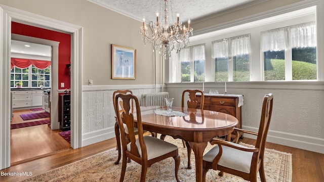 2 Melrose St, Adams, MA 01220 - dining room featuring wood finished floors, ornamental molding, a chandelier, plenty of natural light, and a wainscoted wall
