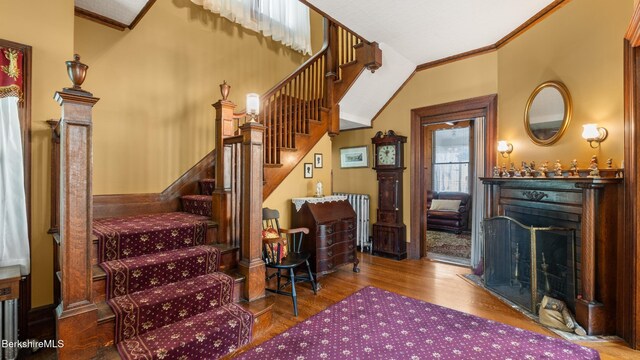 2 Melrose St, Adams, MA 01220 - stairs featuring crown molding, a fireplace with flush hearth, and wood finished floors