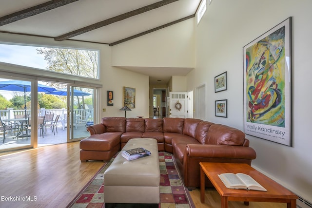 living room with beamed ceiling, high vaulted ceiling, baseboard heating, and wood finished floors