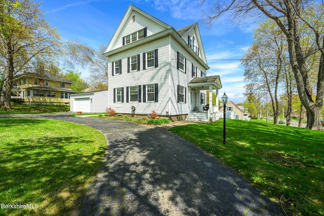 neoclassical / greek revival house with a front lawn and a garage