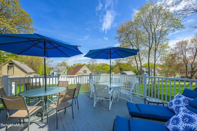 deck featuring a yard and outdoor dining space