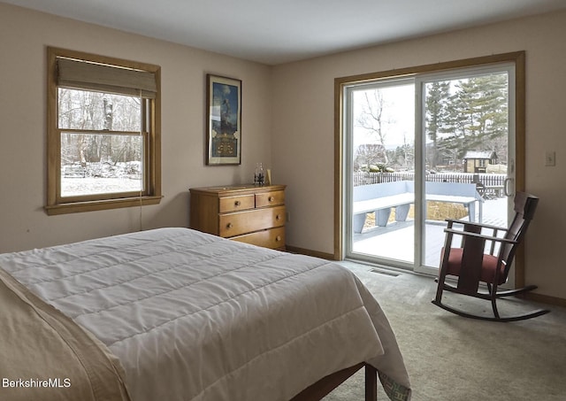 carpeted bedroom with access to exterior