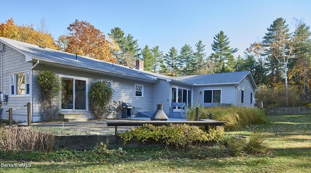 rear view of property with a lawn