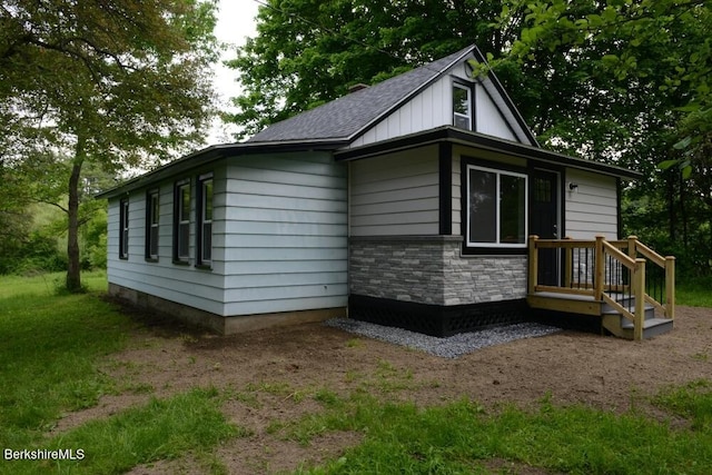 26 Davis St, Pittsfield, MA 01201 - view of home's exterior with a shingled roof and stone siding