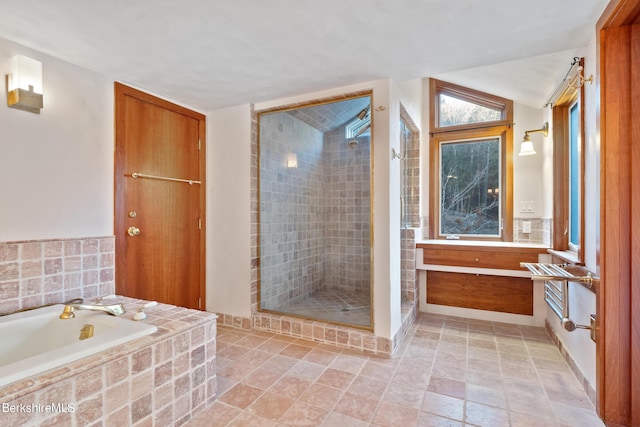 bathroom with lofted ceiling, tile walls, and plus walk in shower