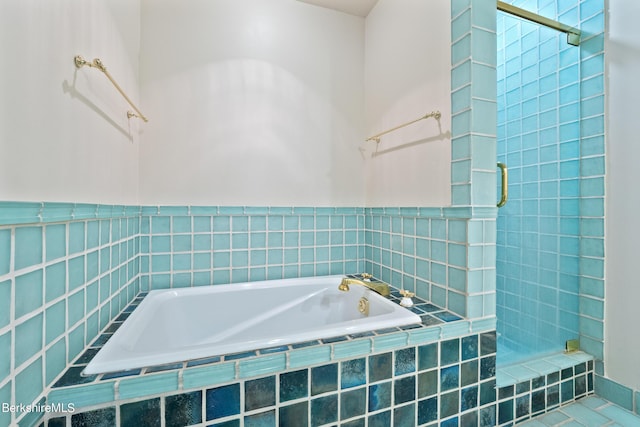 bathroom featuring tile patterned floors and independent shower and bath