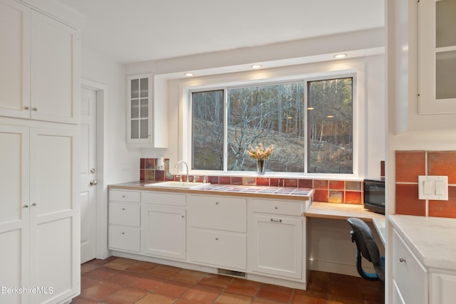 kitchen with white cabinetry and sink