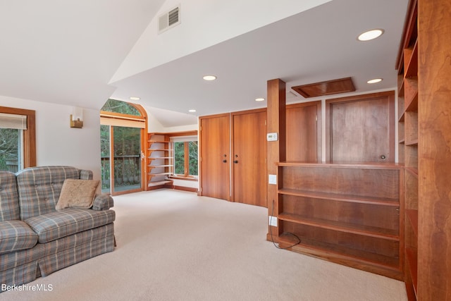 living room featuring light carpet and vaulted ceiling