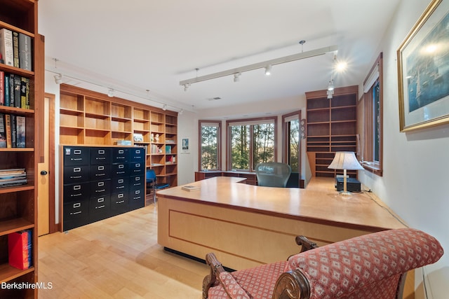 office featuring hardwood / wood-style flooring and rail lighting