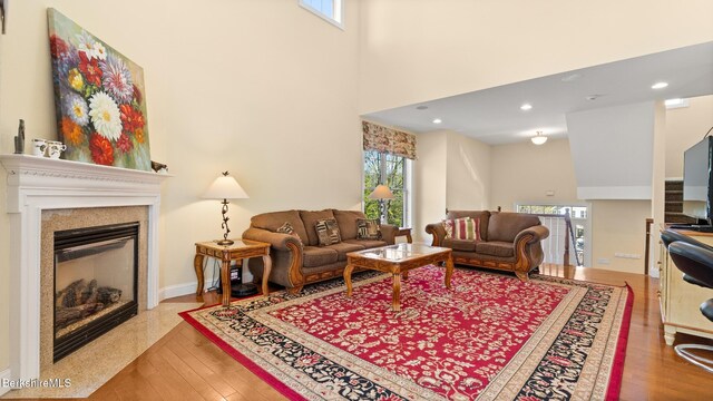 14 Alpine Trl # 14, Pittsfield, MA 01201 - living area with wood finished floors, a high ceiling, visible vents, a glass covered fireplace, and recessed lighting