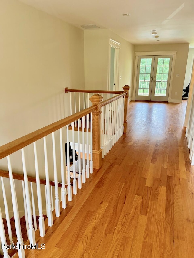 121 E Dugway Rd, Lenox, MA 01240 - corridor featuring french doors, light wood-style floors, and an upstairs landing