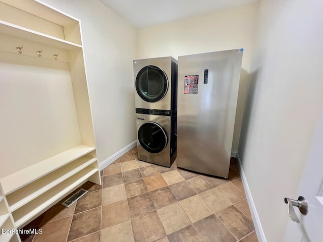 121 E Dugway Rd, Lenox, MA 01240 - laundry area featuring stacked washer and clothes dryer and light stone finish floors
