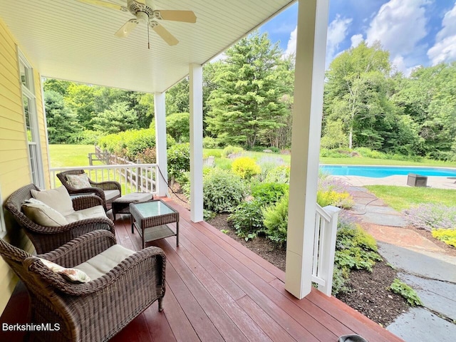 121 E Dugway Rd, Lenox, MA 01240 - wooden deck featuring ceiling fan, an outdoor pool, and view of wooded area